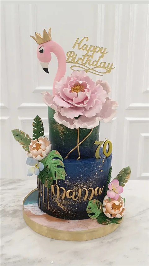Kue ulang tahun Mama ke-70 dengan flamingo merah muda, bunga, daun tropis, dan aksen emas